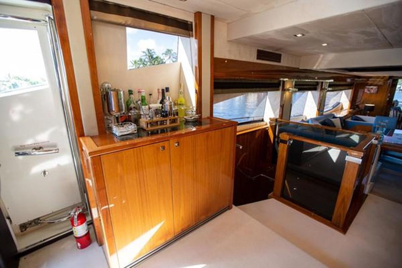 a bar with a bar and a counter with bottles of liquor on it aboard THE CABANA Yacht for Sale
