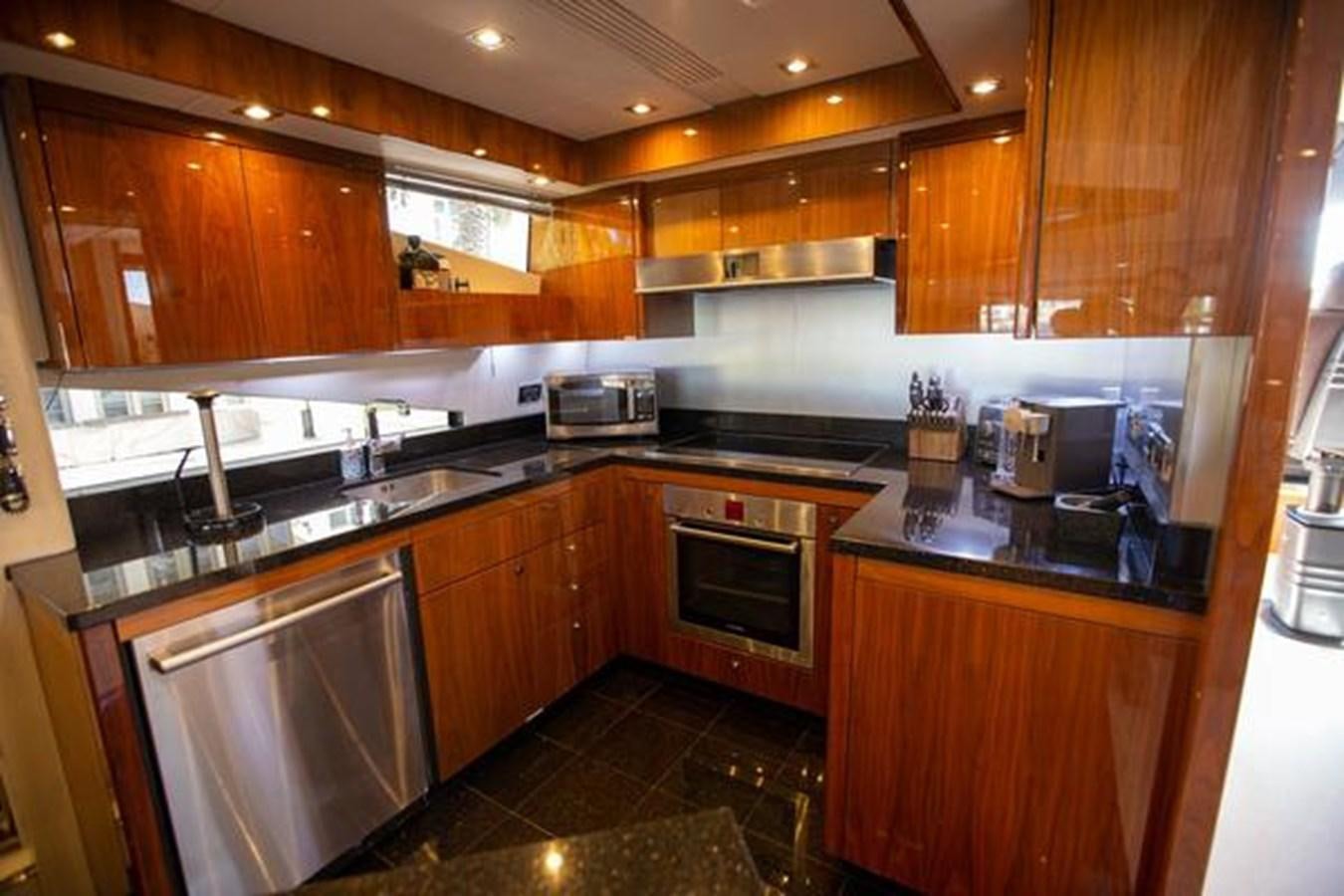 a kitchen with wooden cabinets aboard THE CABANA Yacht for Sale