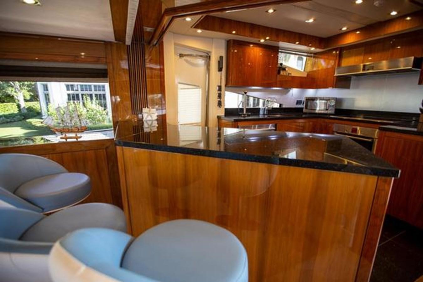a kitchen with wooden cabinets aboard THE CABANA Yacht for Sale
