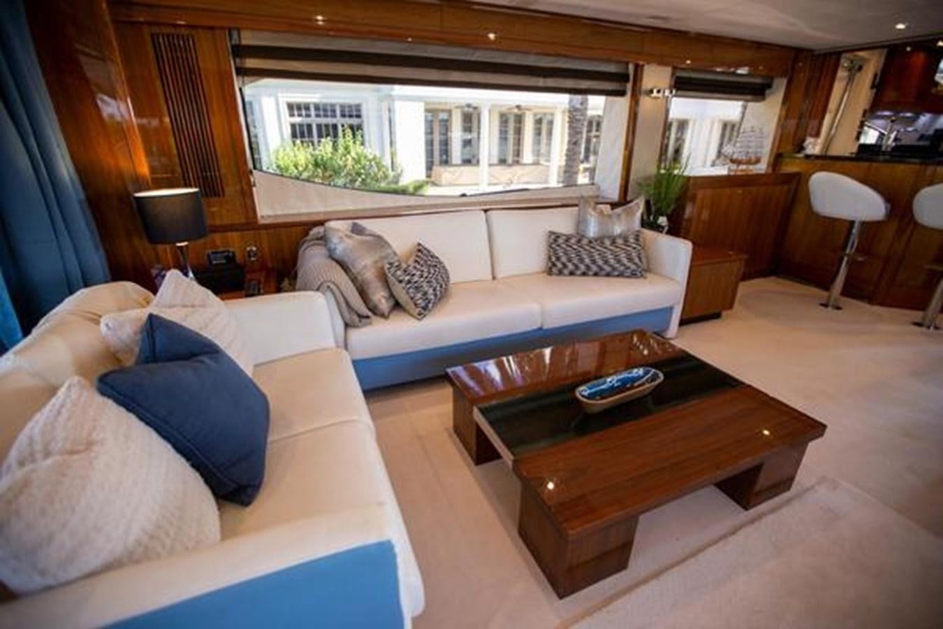 a living room with a couch and a coffee table aboard THE CABANA Yacht for Sale