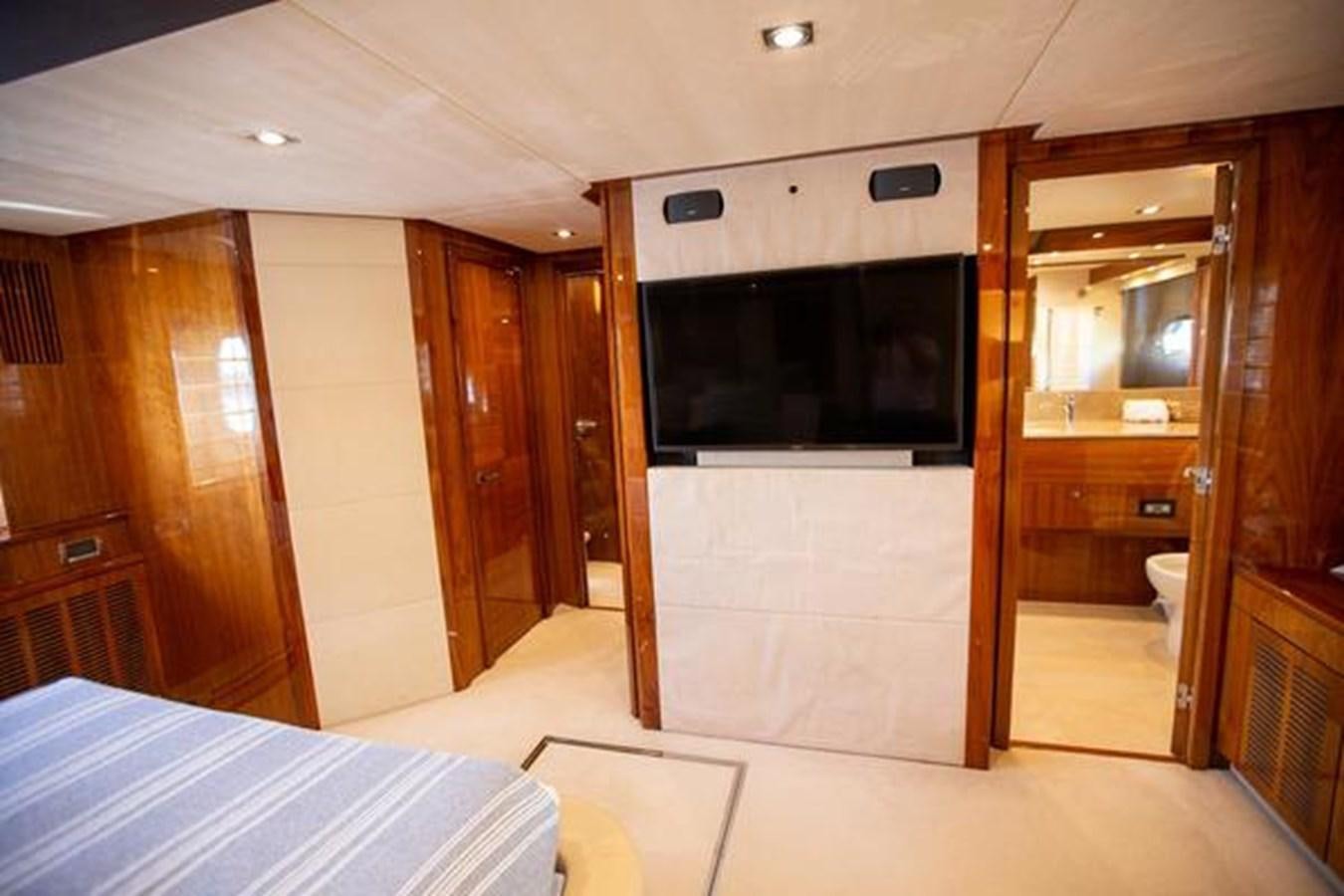 a hotel room with a bed and tv aboard THE CABANA Yacht for Sale