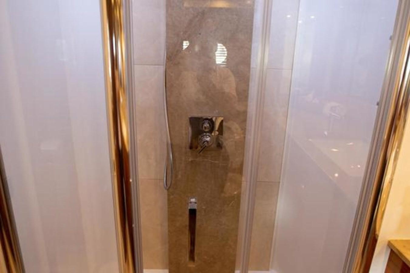 a dog in a shower aboard THE CABANA Yacht for Sale