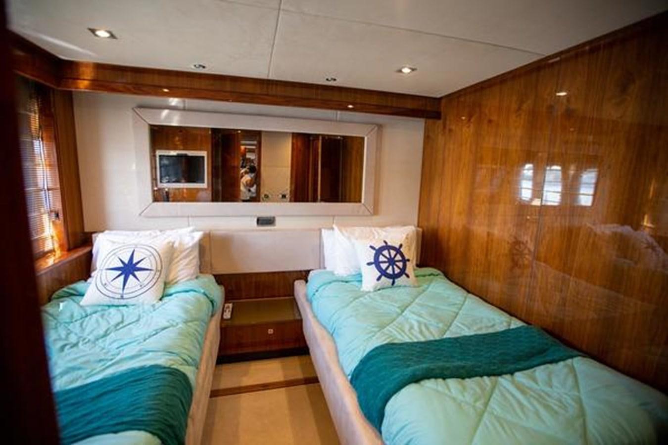 a room with a bed and a mirror aboard THE CABANA Yacht for Sale