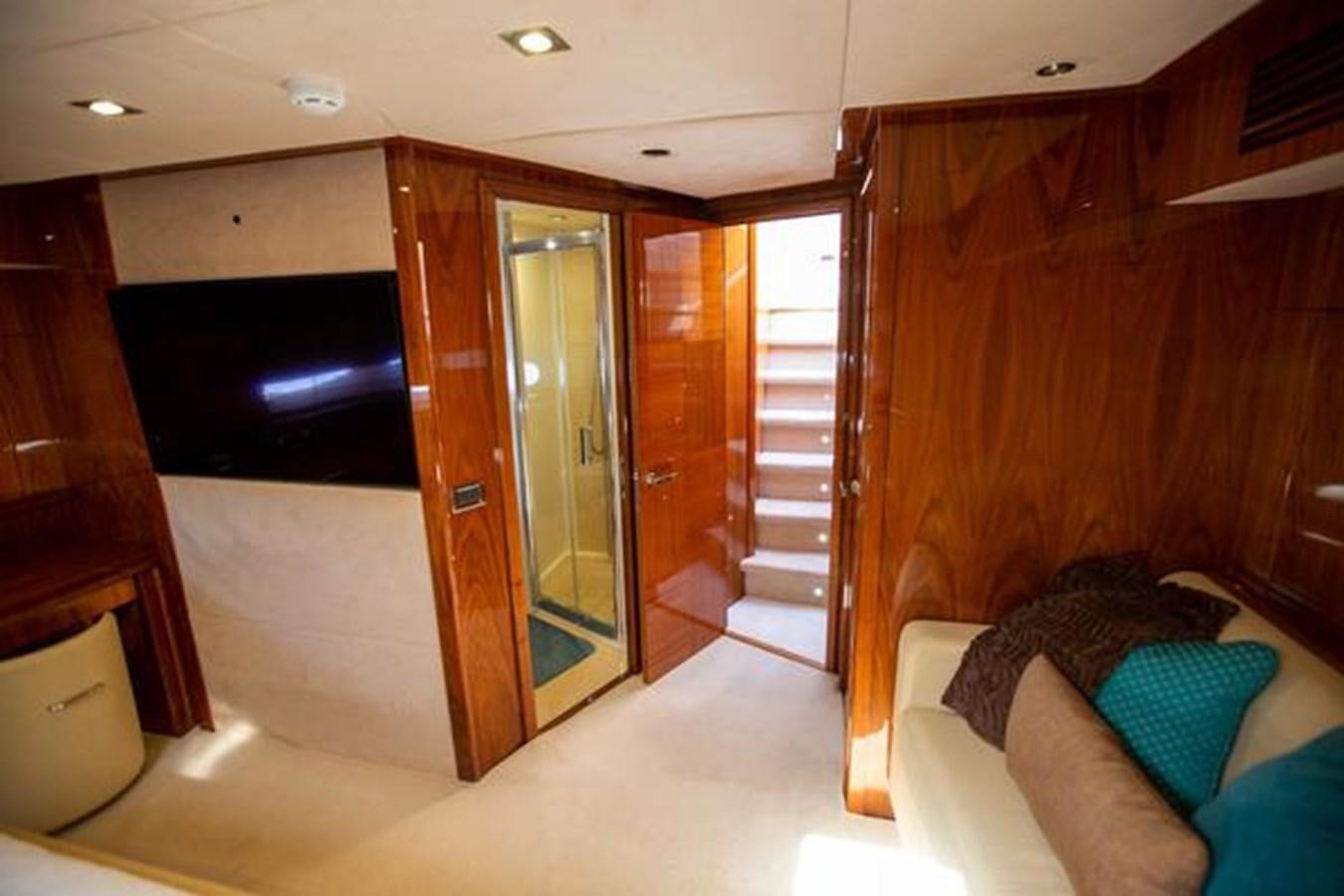 a room with a bed and a wood wall aboard THE CABANA Yacht for Sale