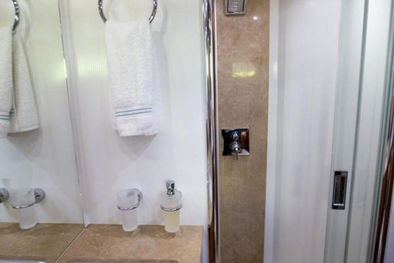 a bathroom with a shower curtain aboard THE CABANA Yacht for Sale