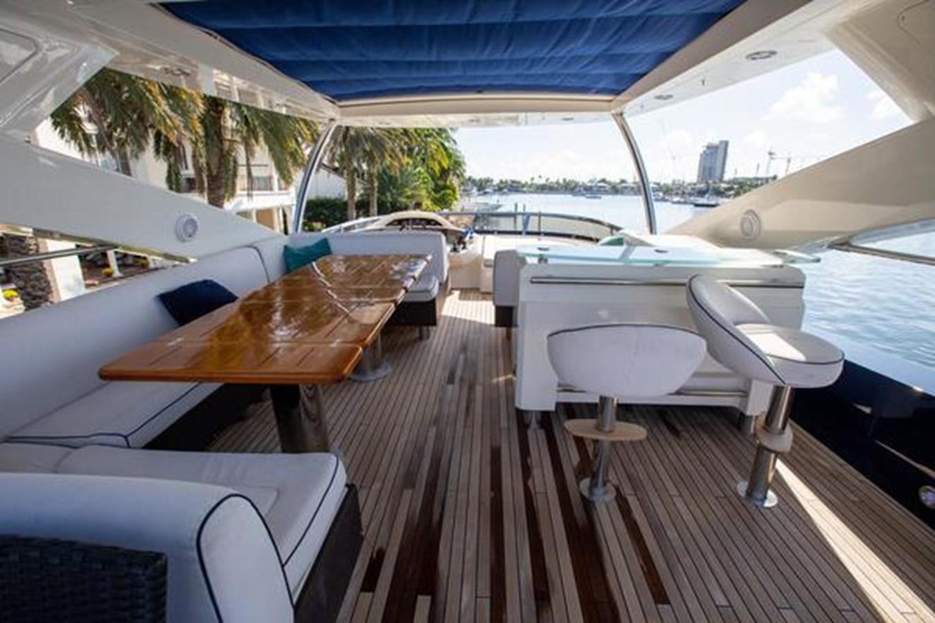 a boat deck with chairs and a boat on it aboard THE CABANA Yacht for Sale