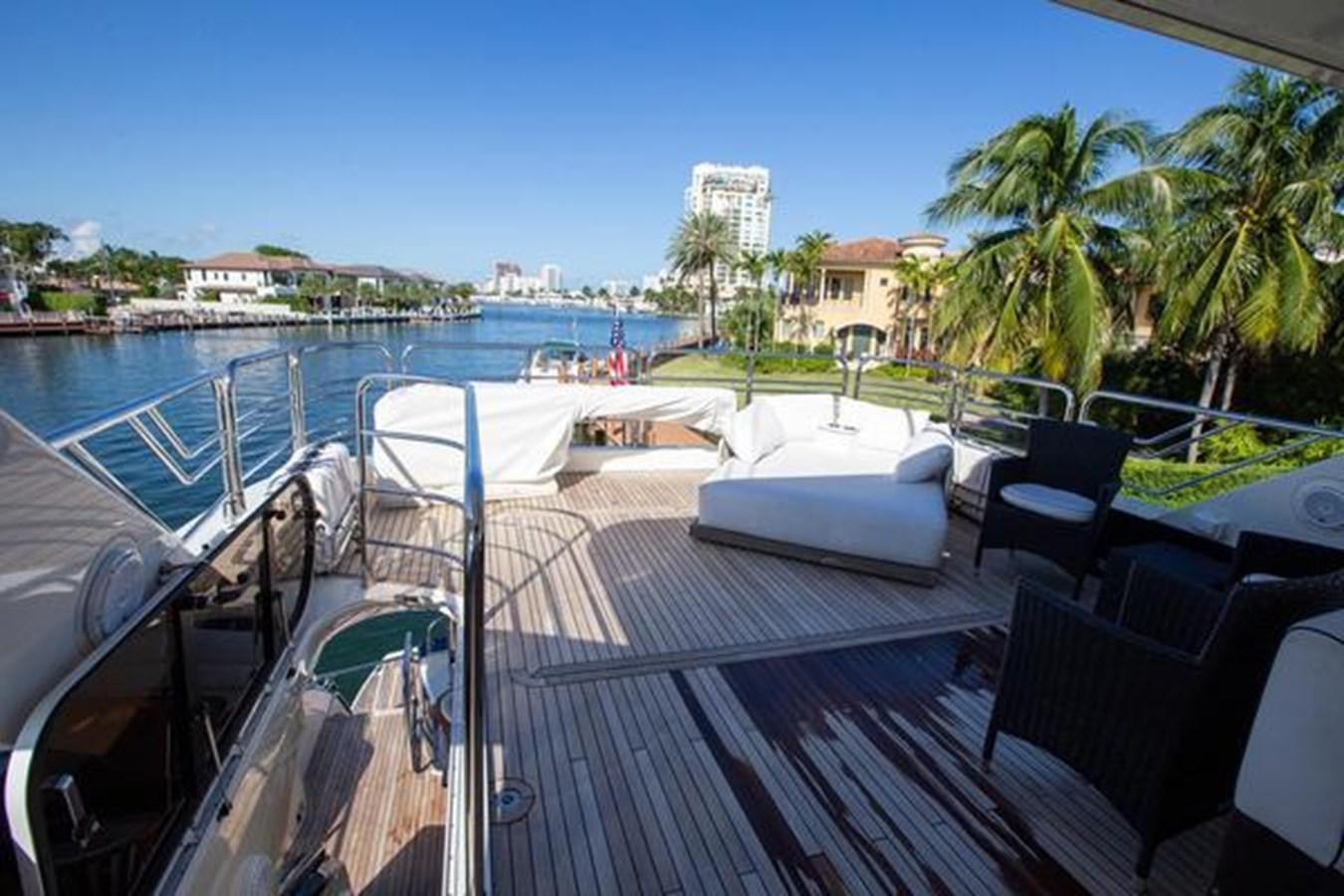 a deck with a pool and chairs aboard THE CABANA Yacht for Sale