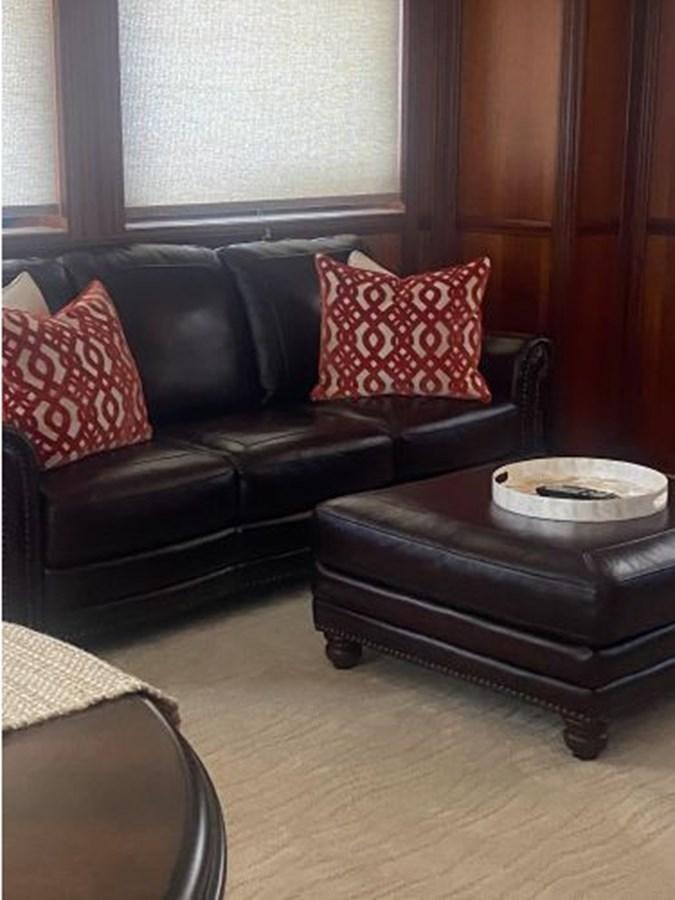 a leather couch with pillows aboard ALLSEAS 92 EXPEDITION Yacht for Sale