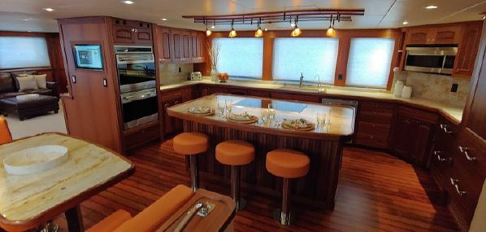 a kitchen with wooden cabinets aboard ALLSEAS 92 EXPEDITION Yacht for Sale