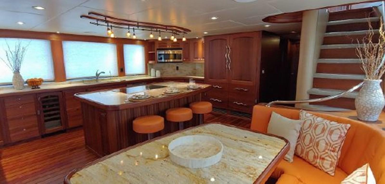 a large kitchen with wooden cabinets aboard ALLSEAS 92 EXPEDITION Yacht for Sale
