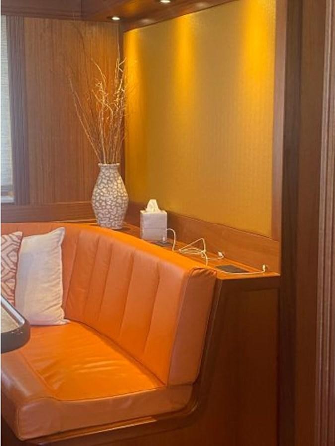 a couch and a vase on a table aboard ALLSEAS 92 EXPEDITION Yacht for Sale