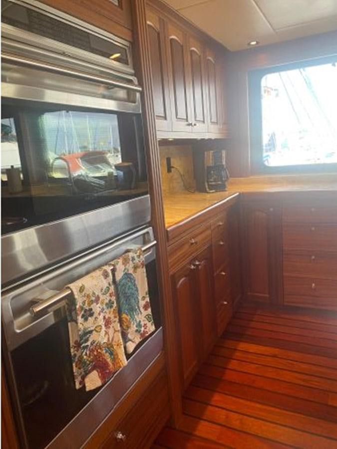 a kitchen with a stove and cabinets aboard ALLSEAS 92 EXPEDITION Yacht for Sale