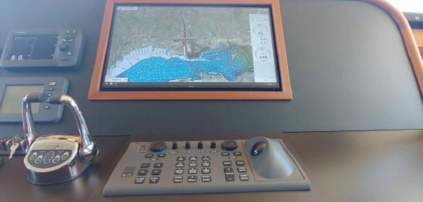 a desk with a computer and a phone aboard ALLSEAS 92 EXPEDITION Yacht for Sale