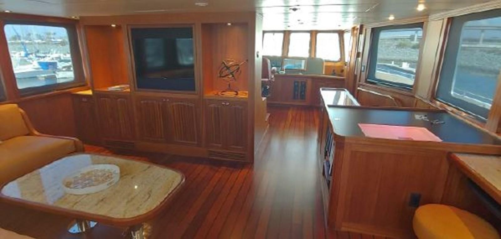 a large kitchen with a table and chairs aboard ALLSEAS 92 EXPEDITION Yacht for Sale