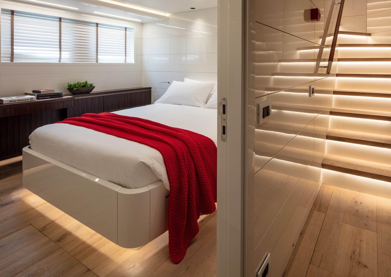 a bedroom with a bed and a desk aboard K584 HULL 2 Yacht for Sale