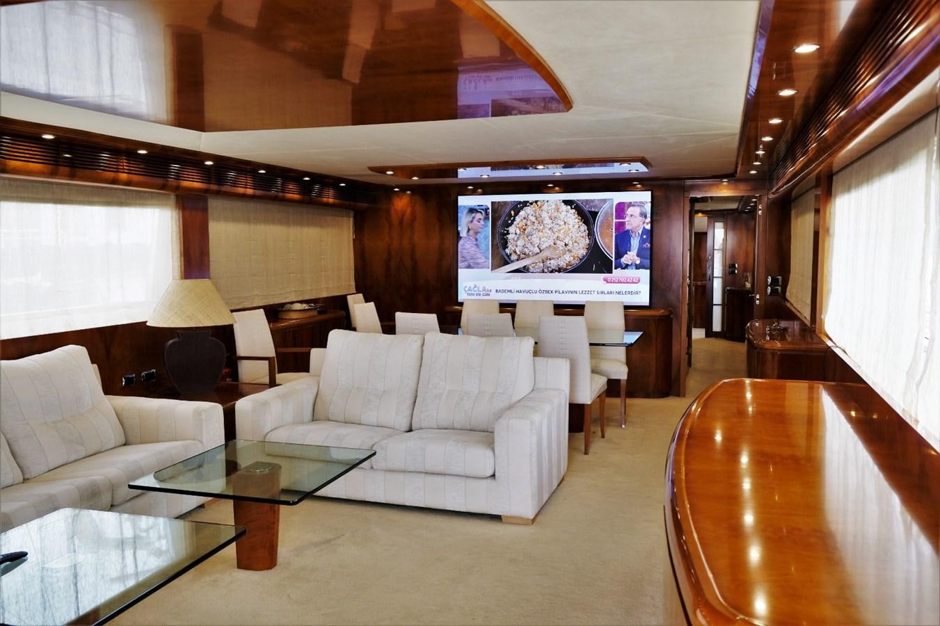 a living room with a large screen aboard WONDERLAND Yacht for Sale