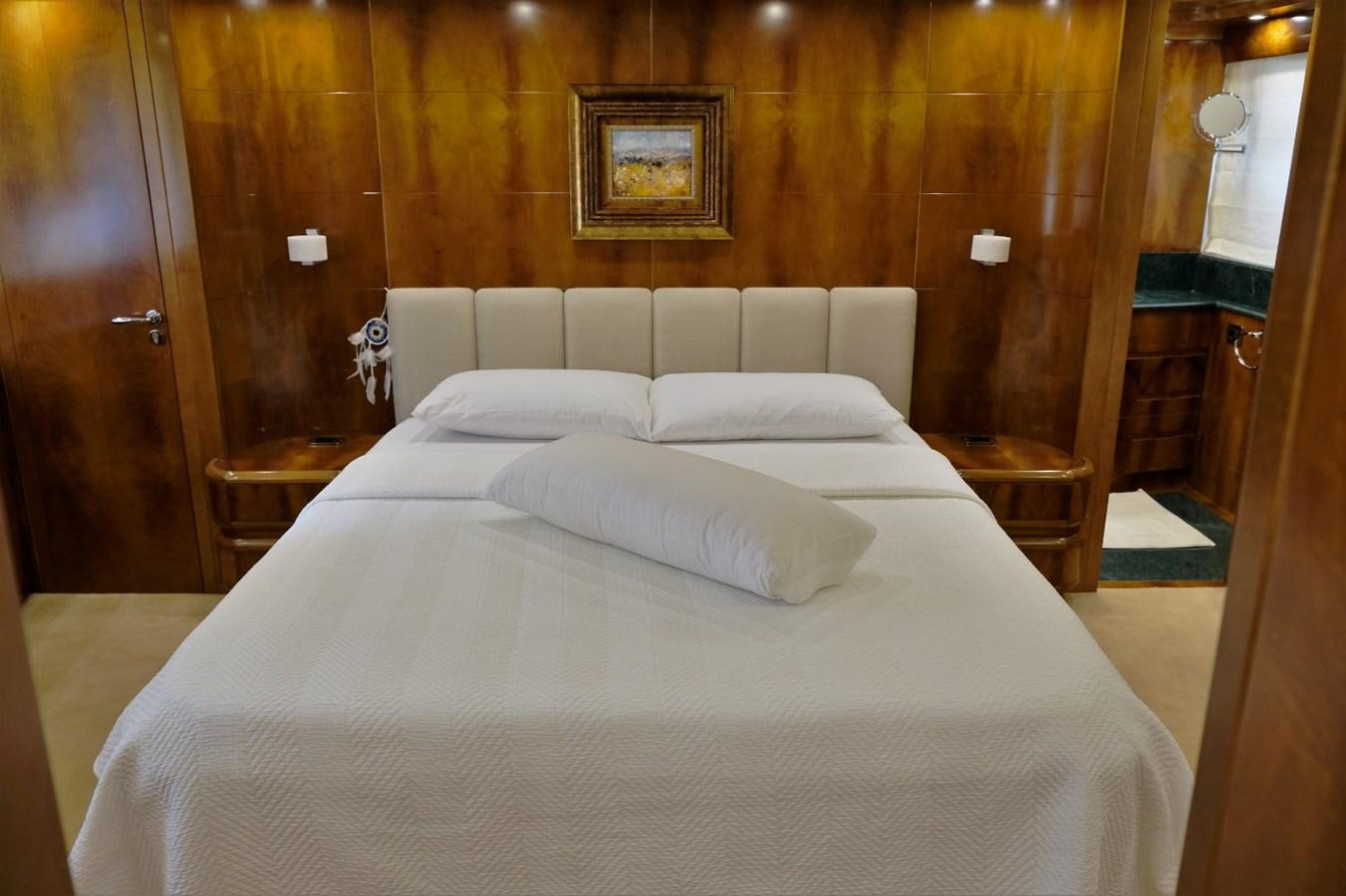 a bed with white sheets aboard WONDERLAND Yacht for Sale