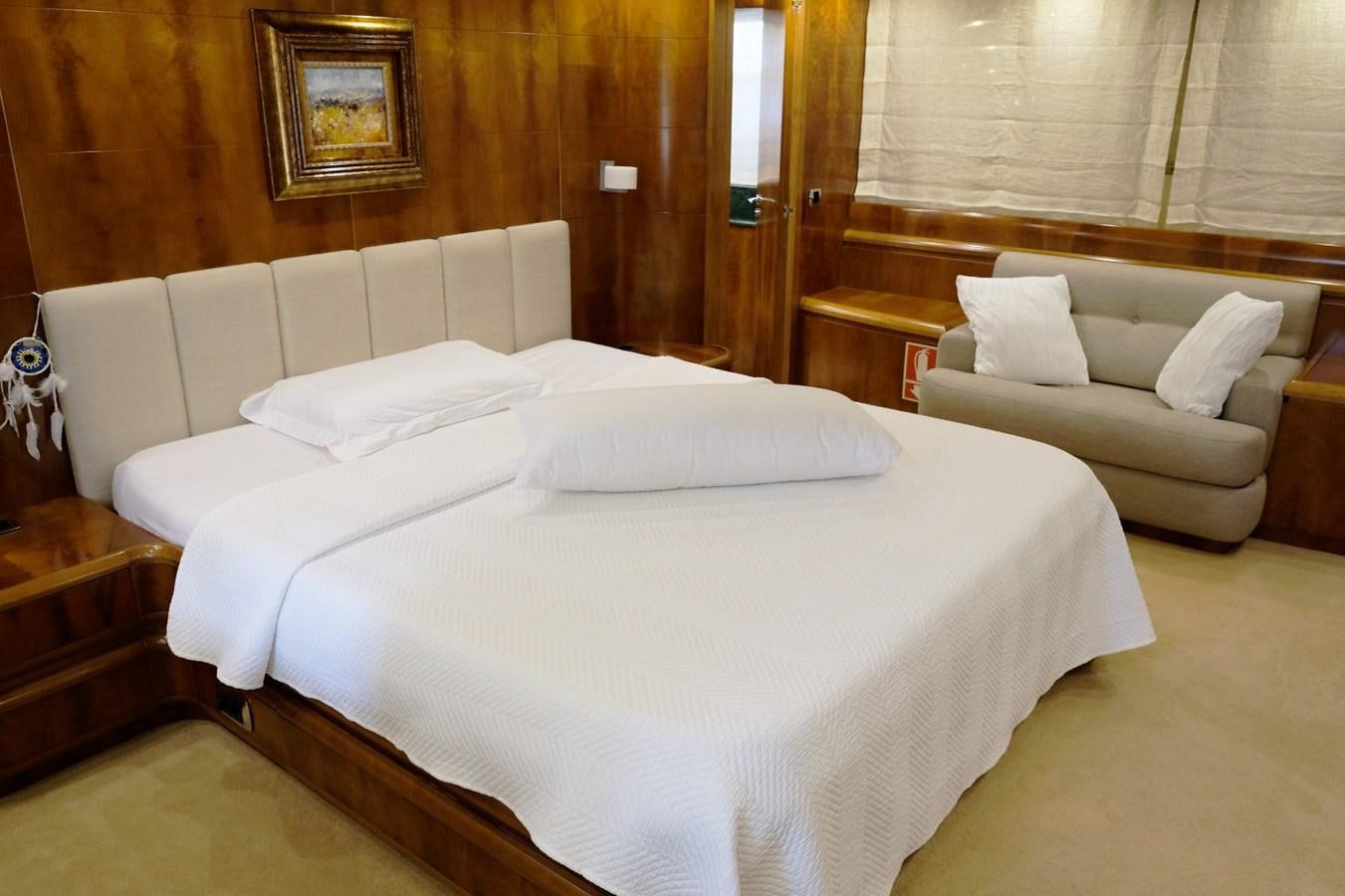 a room with a bed and a couch aboard WONDERLAND Yacht for Sale