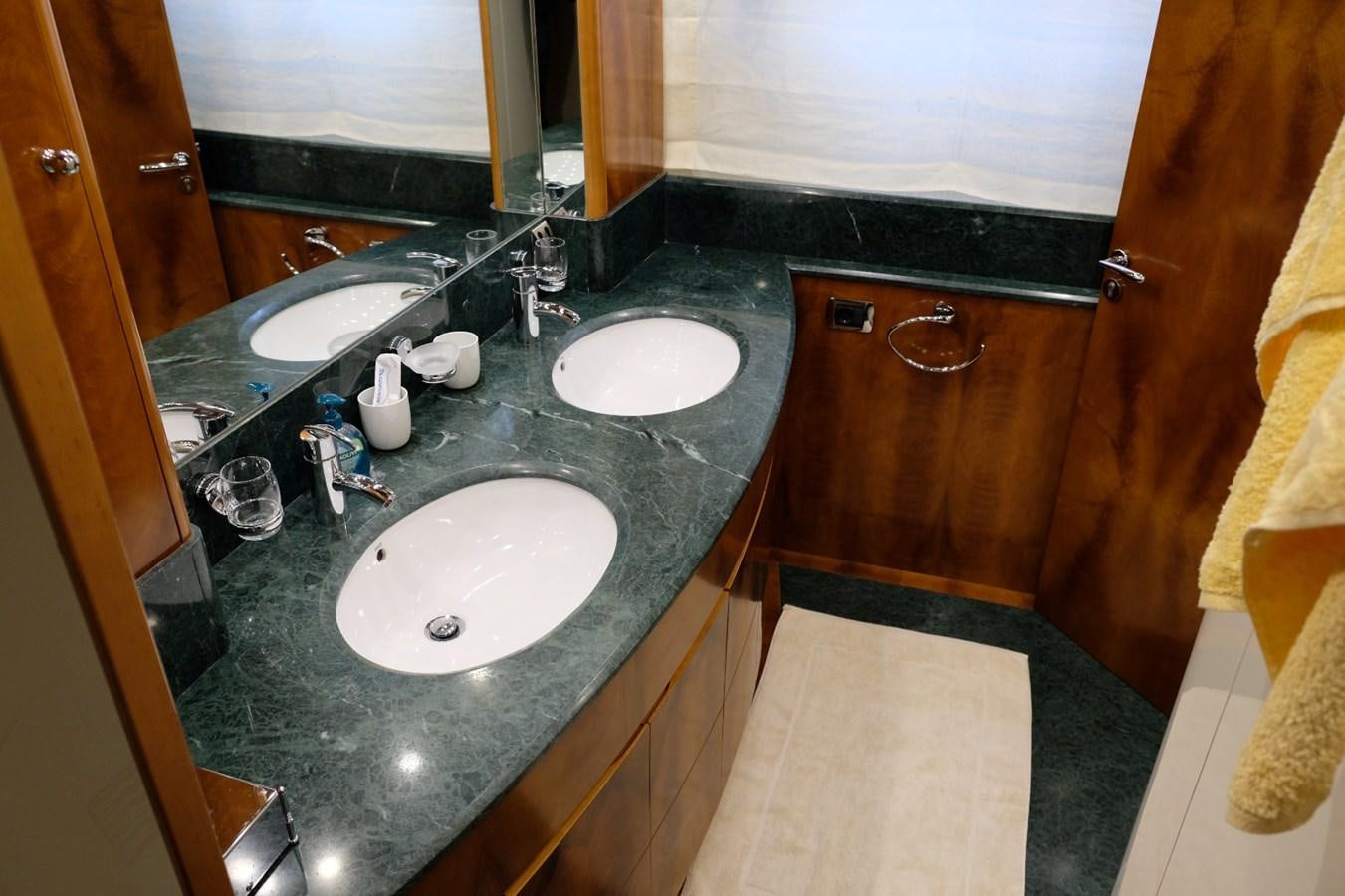 a bathroom with a countertop sink and a mirror aboard WONDERLAND Yacht for Sale