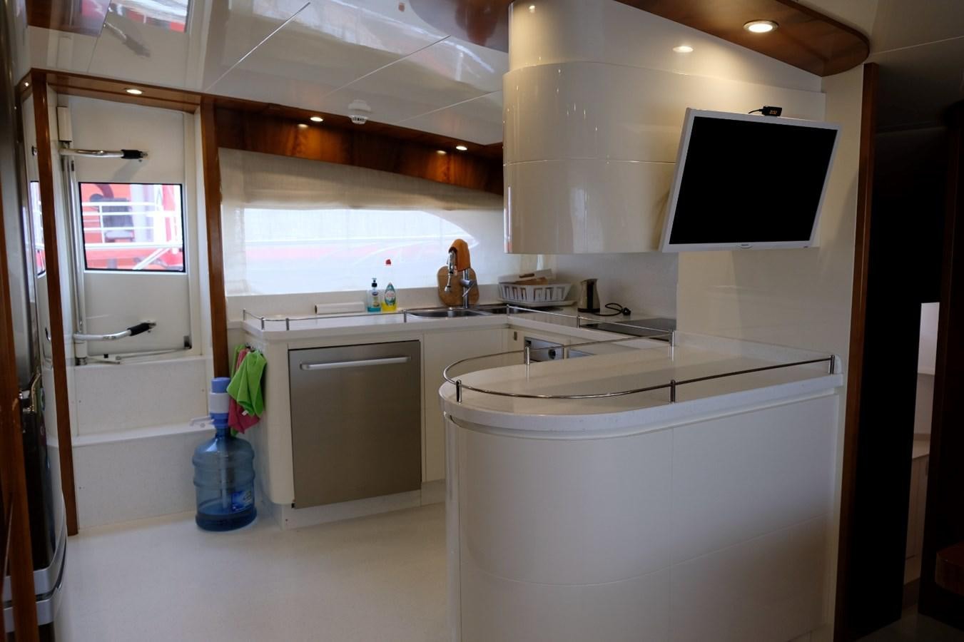 a kitchen with a sink and a tv aboard WONDERLAND Yacht for Sale