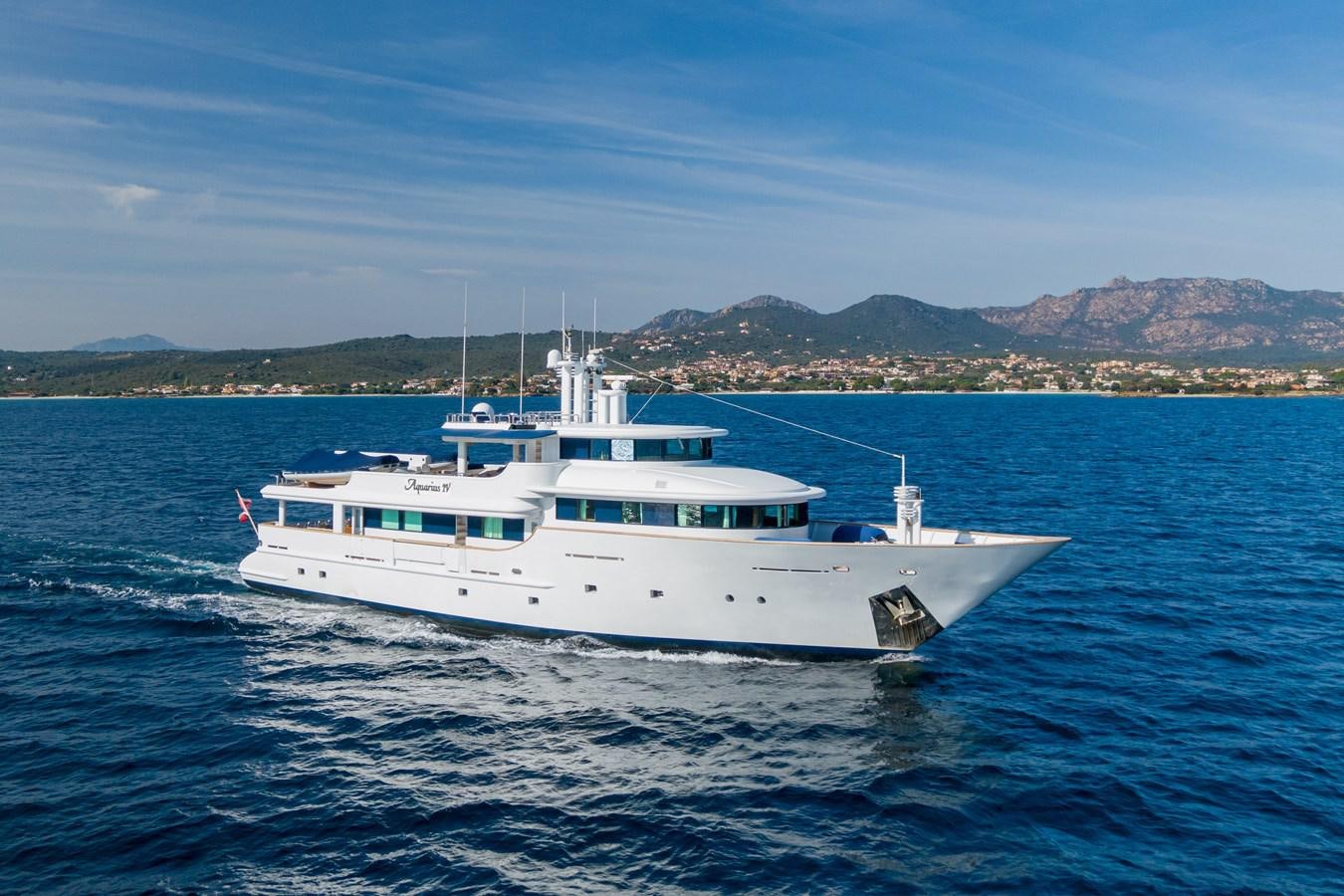 a white boat on the water aboard AQUARIUS IV Yacht for Sale