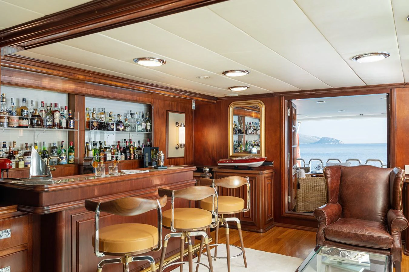 a bar with a bar and stools aboard AQUARIUS IV Yacht for Sale