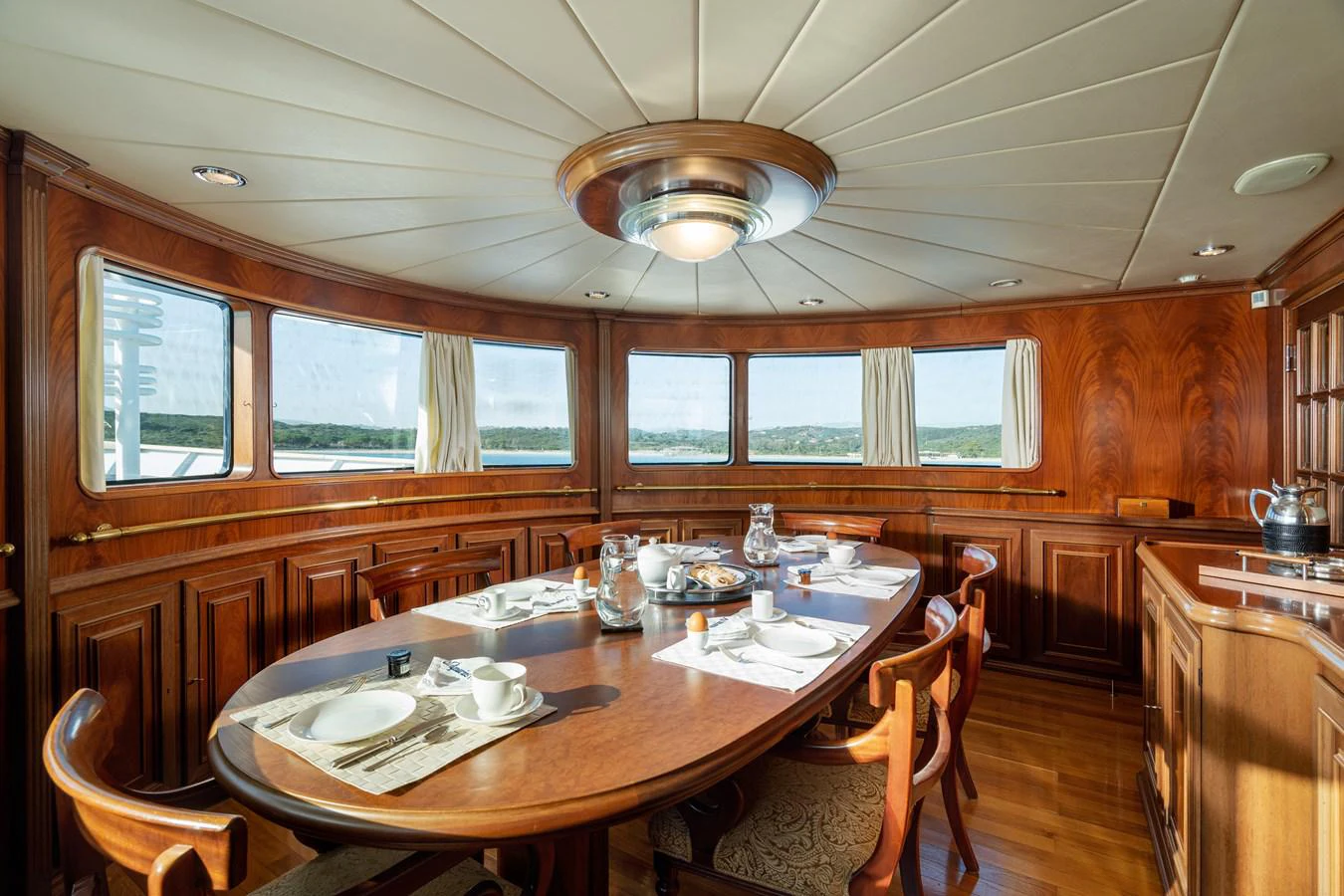 a kitchen with a dining table aboard AQUARIUS IV Yacht for Sale