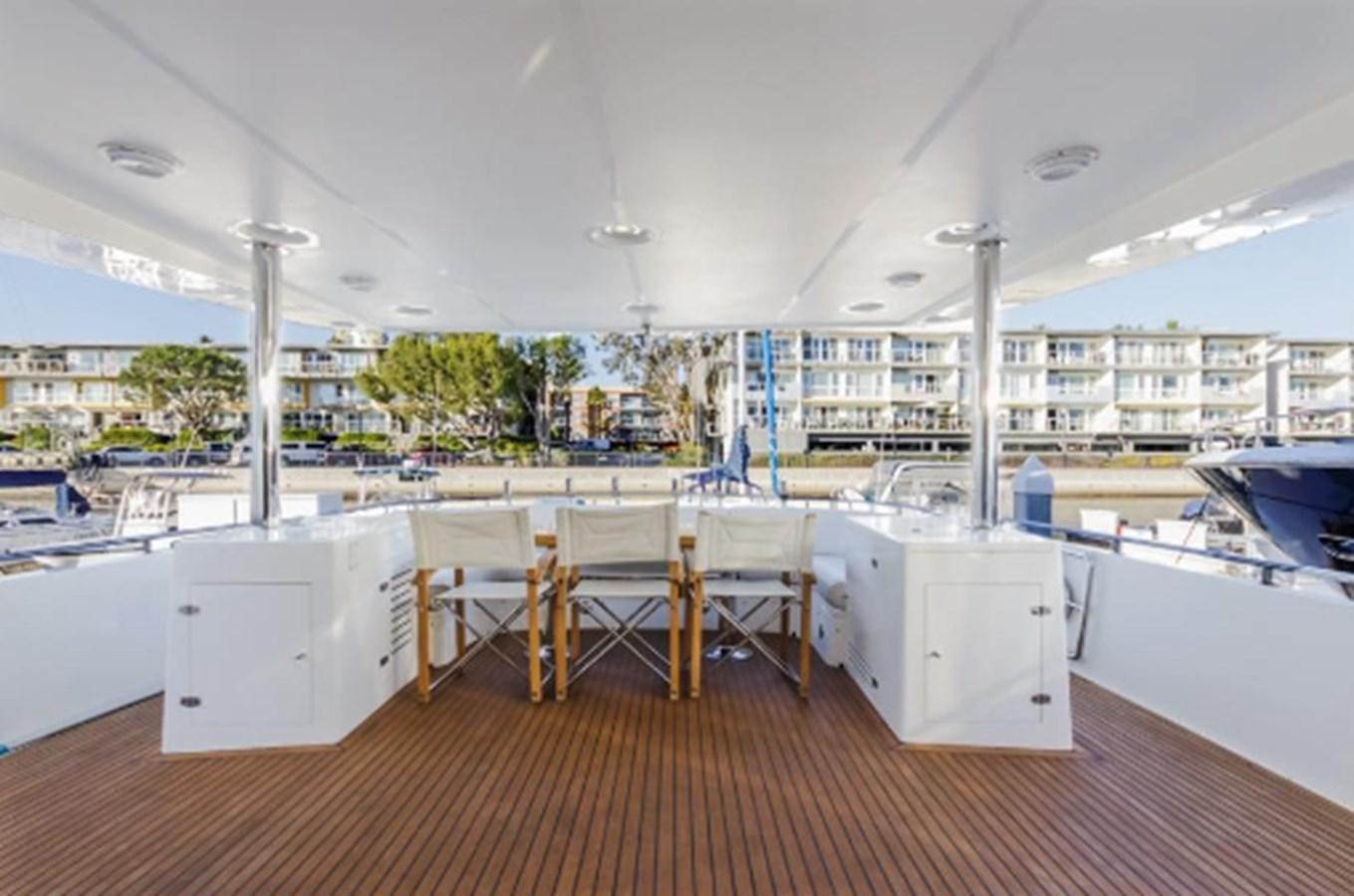 a room with tables and chairs aboard THE FLYING WASP Yacht for Sale