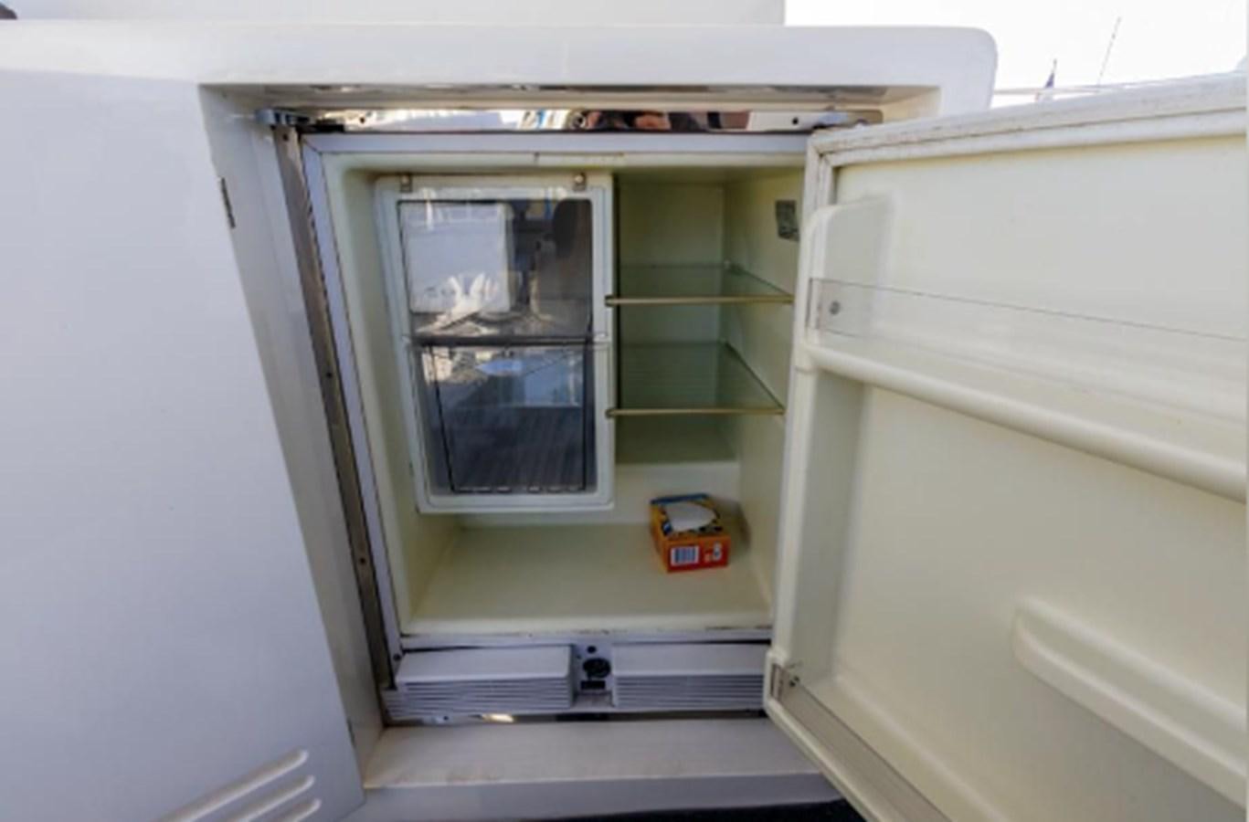 a small refrigerator with a door open aboard THE FLYING WASP Yacht for Sale