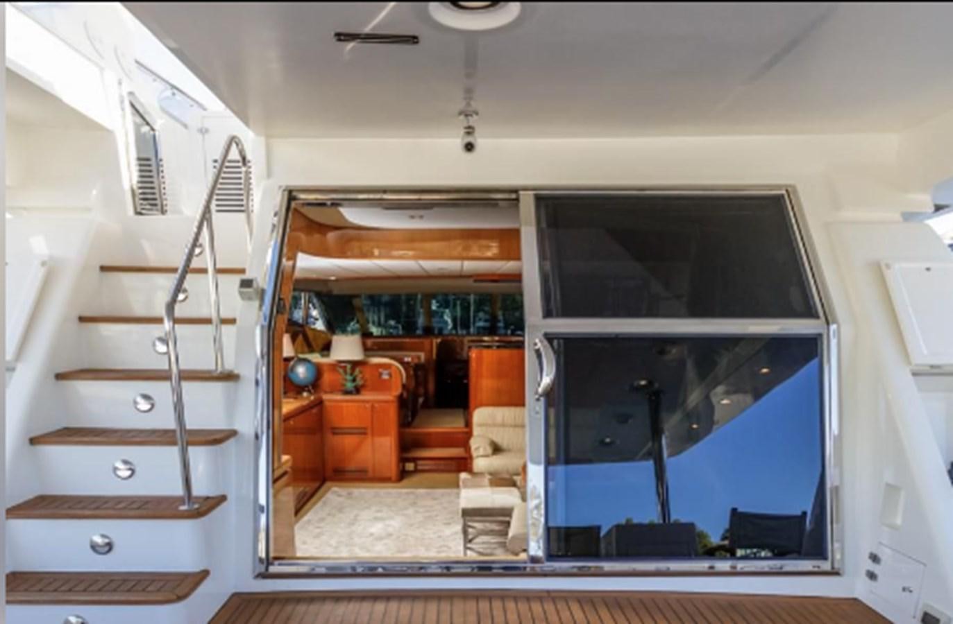 a room with a glass door and a staircase aboard THE FLYING WASP Yacht for Sale