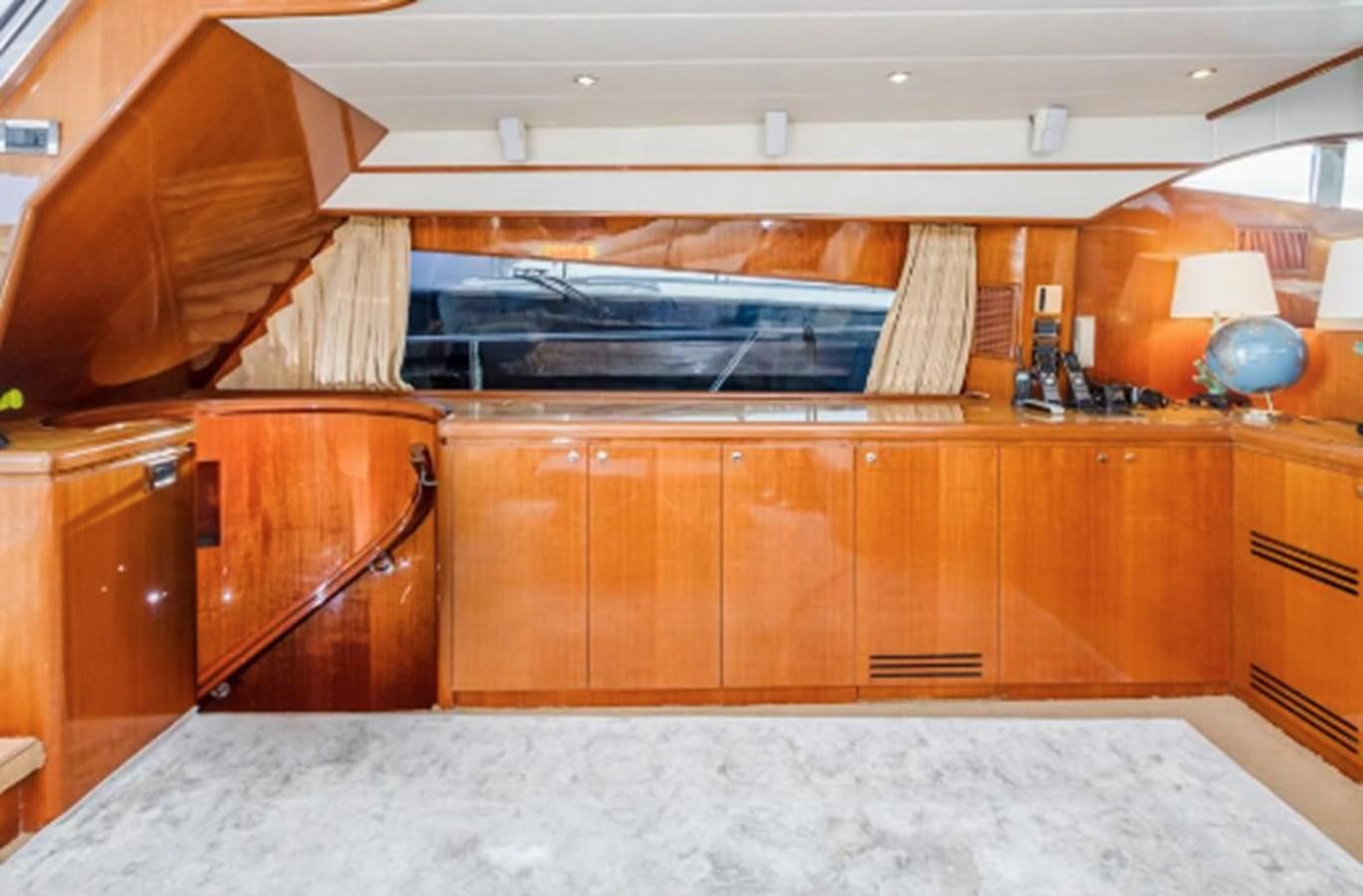 a kitchen with wooden cabinets aboard JOHNSON 70' FLYBRIDGE M/Y Yacht for Sale