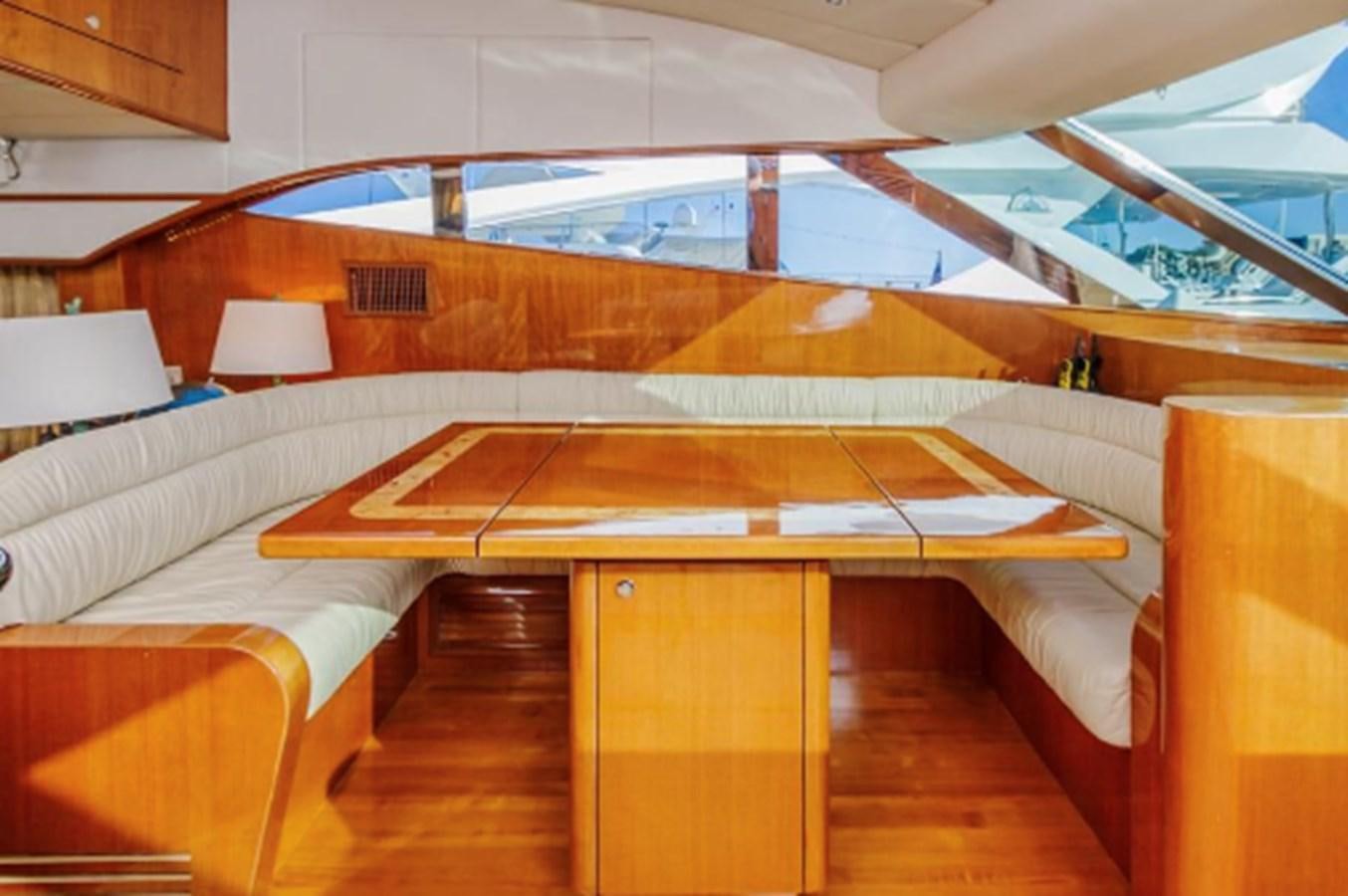 a room with a bed and a table aboard THE FLYING WASP Yacht for Sale