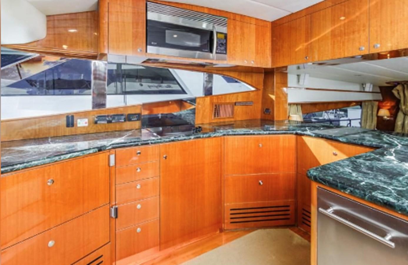 a kitchen with wooden cabinets aboard THE FLYING WASP Yacht for Sale