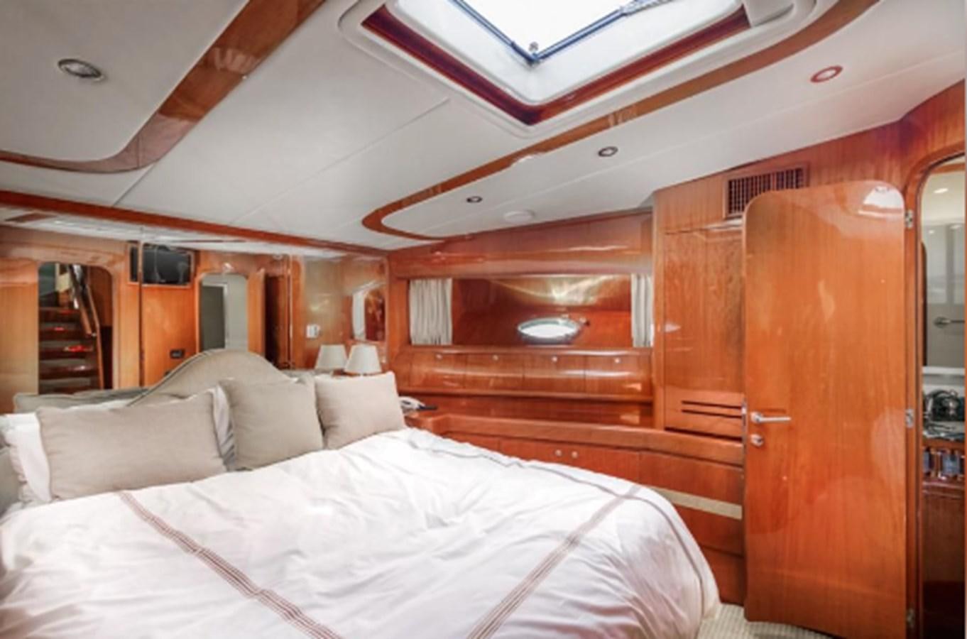 a room with a bed and a window aboard THE FLYING WASP Yacht for Sale