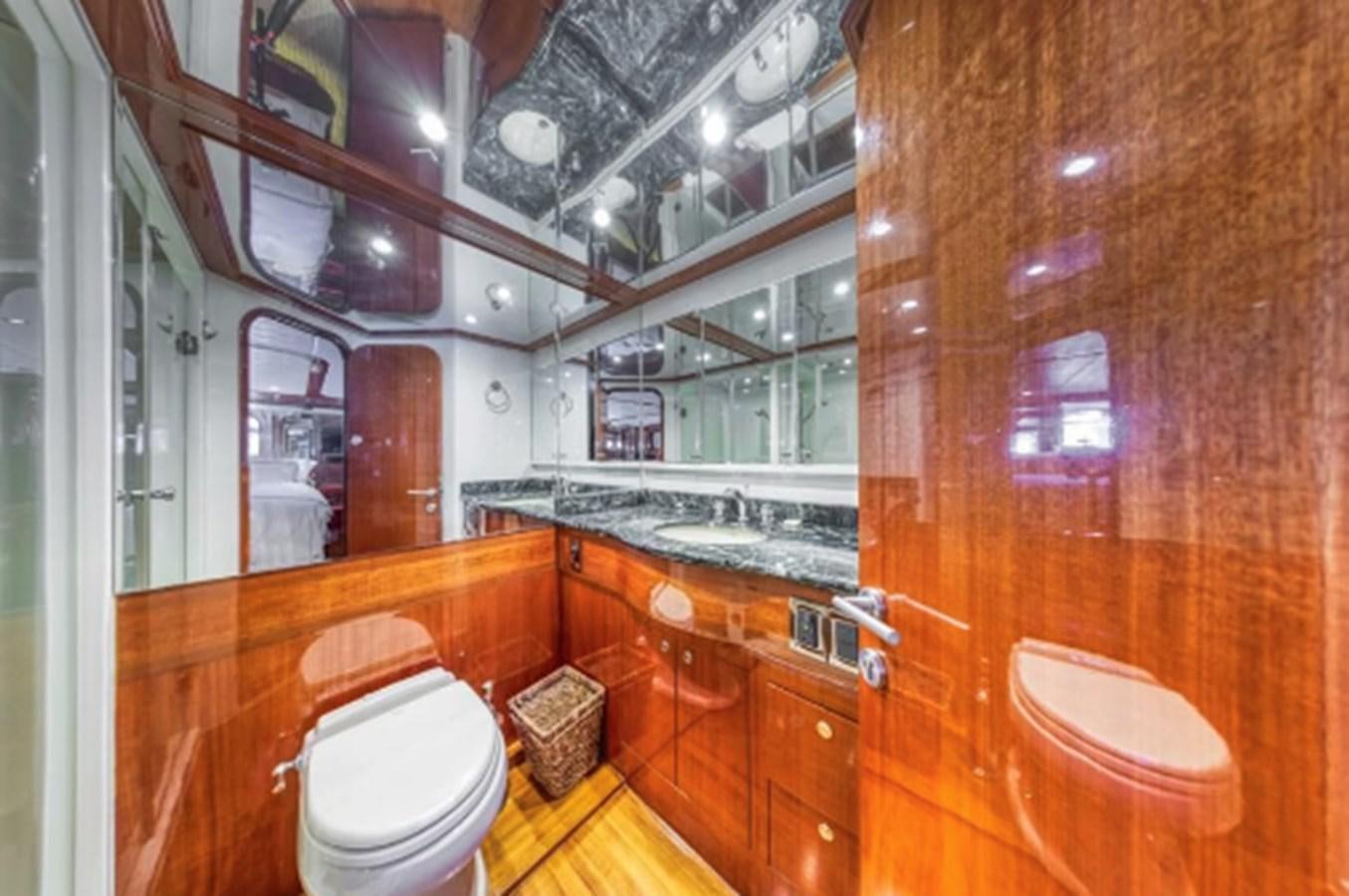 a bathroom with a toilet and sink aboard THE FLYING WASP Yacht for Sale