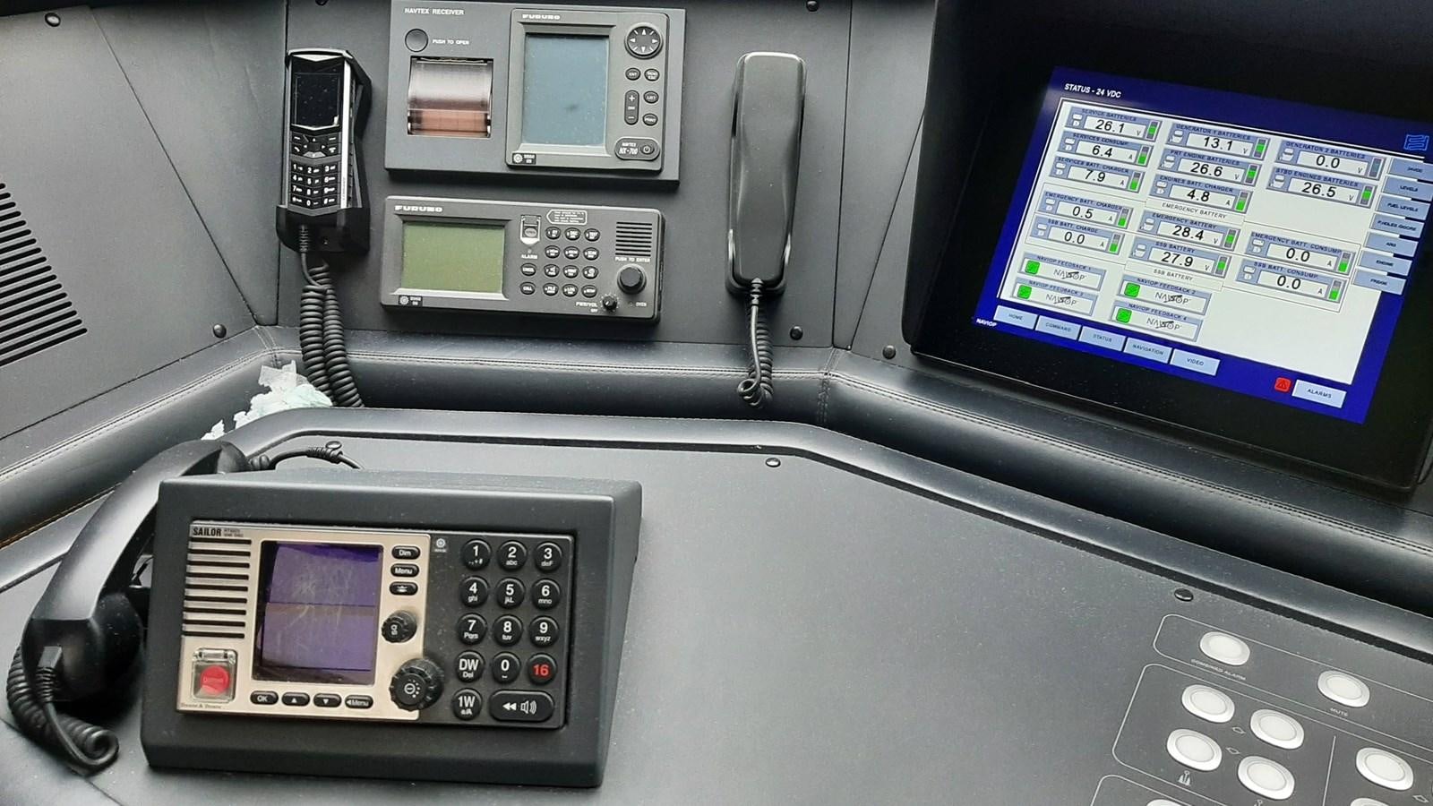 a couple of cell phones on a table aboard OKAMI Yacht for Sale