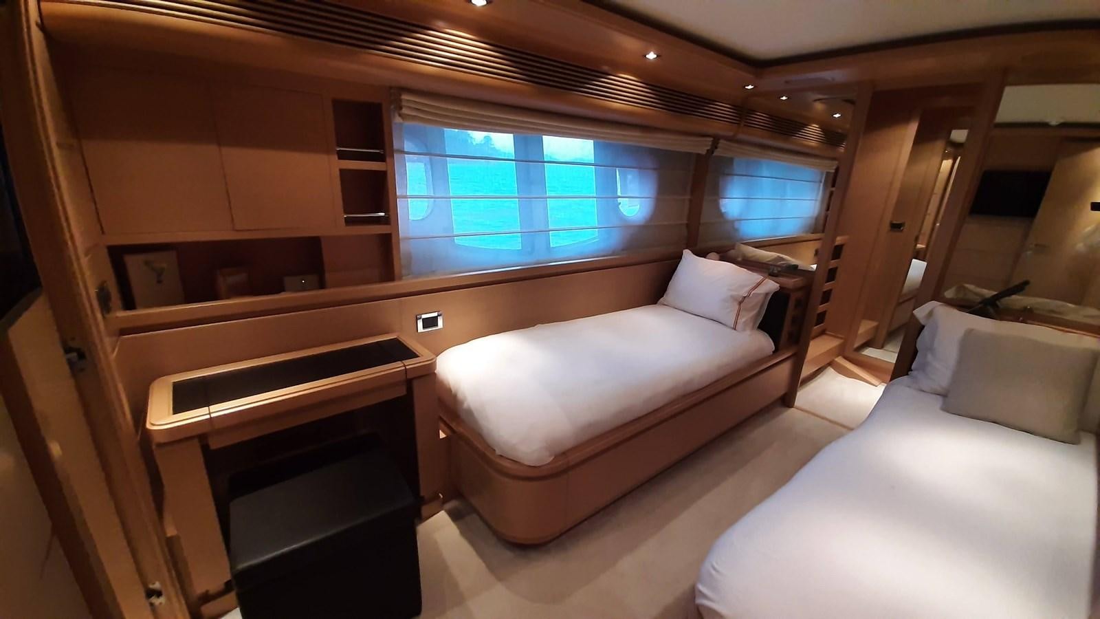 a room with a bed and a window aboard OKAMI Yacht for Sale