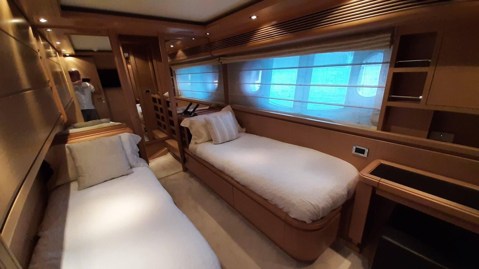 a room with a bed and a window aboard OKAMI Yacht for Sale