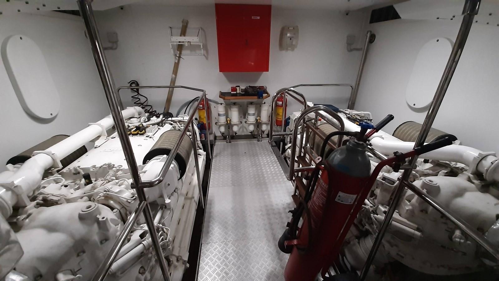 a room with white chairs and red walls aboard OKAMI Yacht for Sale