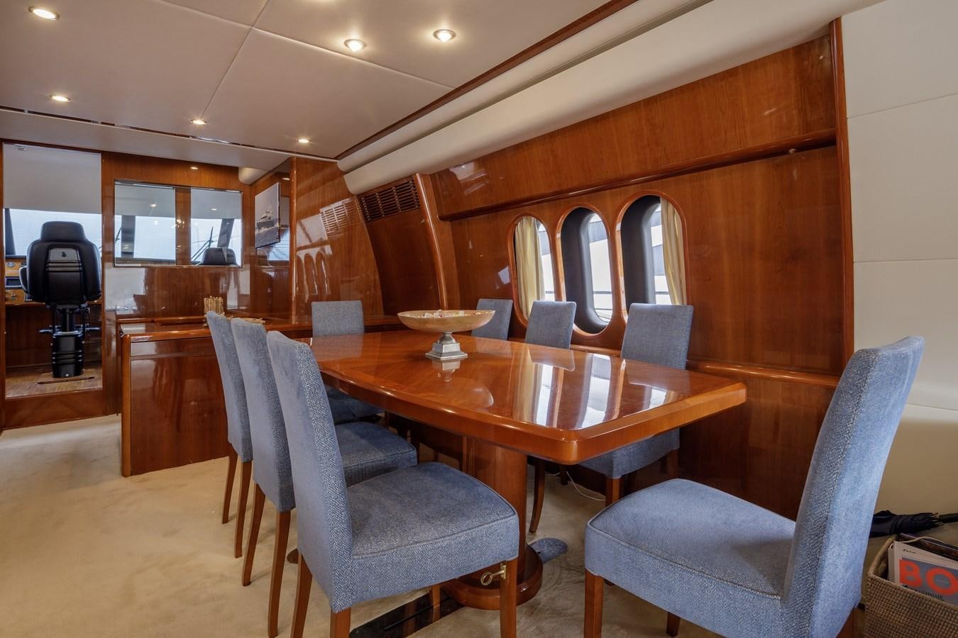 a dining table and chairs in a room with wood walls aboard TAMARA S Yacht for Sale