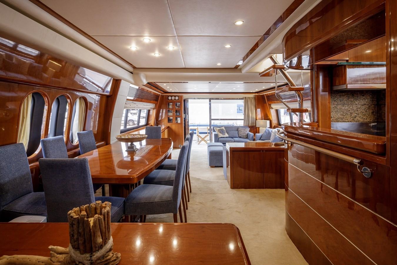 a large room with a wood table and chairs aboard TAMARA S Yacht for Sale