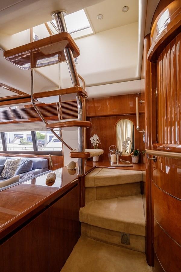 a wooden cabin with a bed and a mirror aboard TAMARA S Yacht for Sale