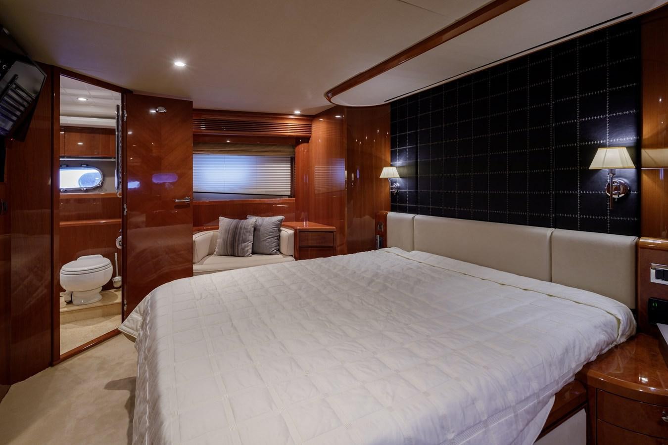 a bedroom with a bed and a mirror aboard TAMARA S Yacht for Sale