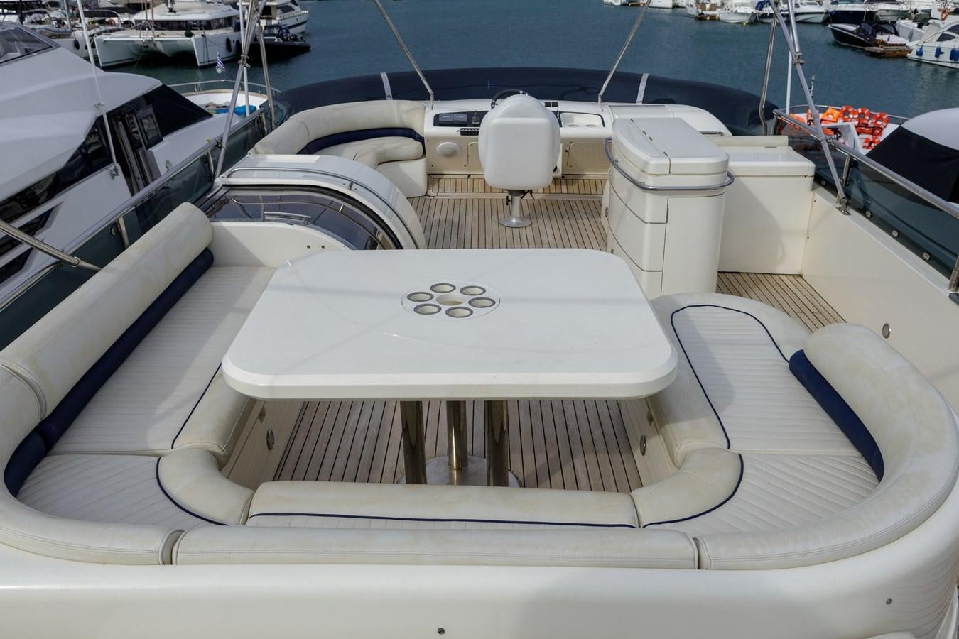 a boat with a white table and chairs on it aboard TAMARA S Yacht for Sale