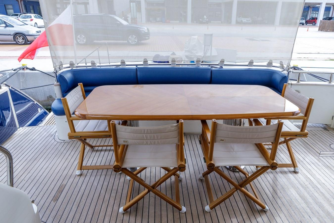 a table and chairs on a deck aboard TAMARA S Yacht for Sale