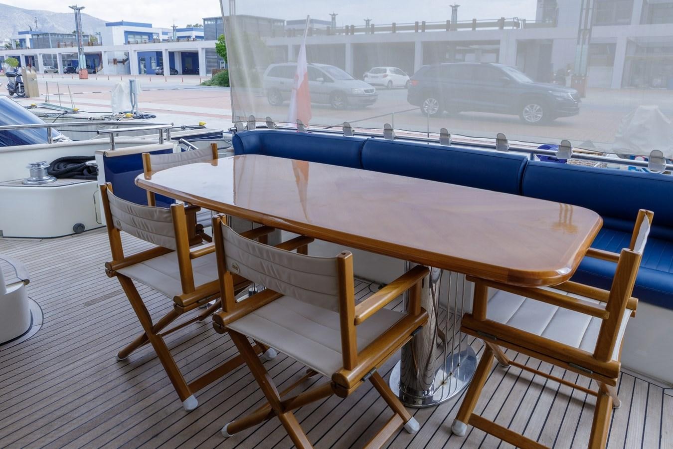 a table and chairs on a deck aboard TAMARA S Yacht for Sale