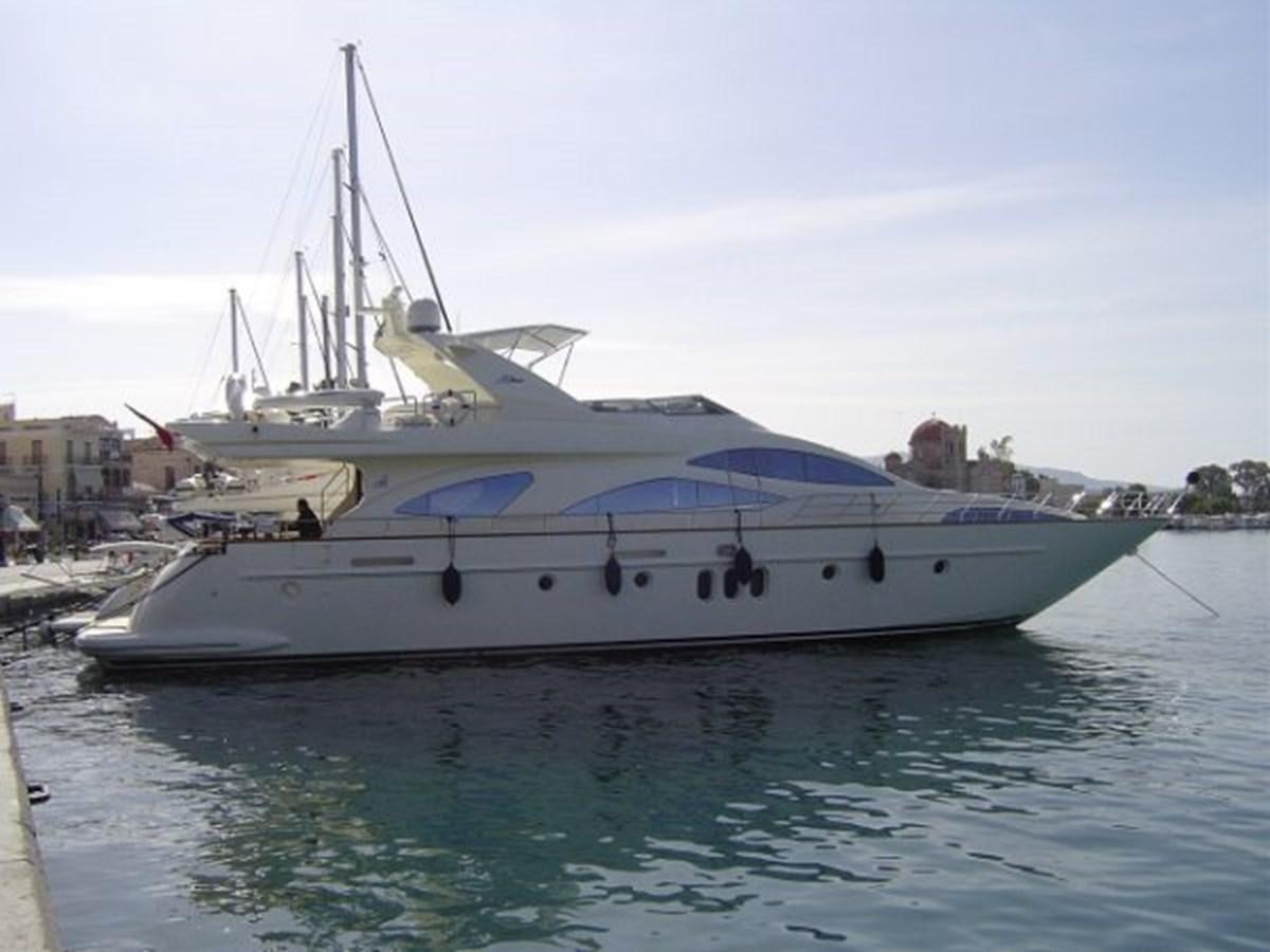 a white yacht in a harbor aboard FREE SPIRIT Yacht for Sale