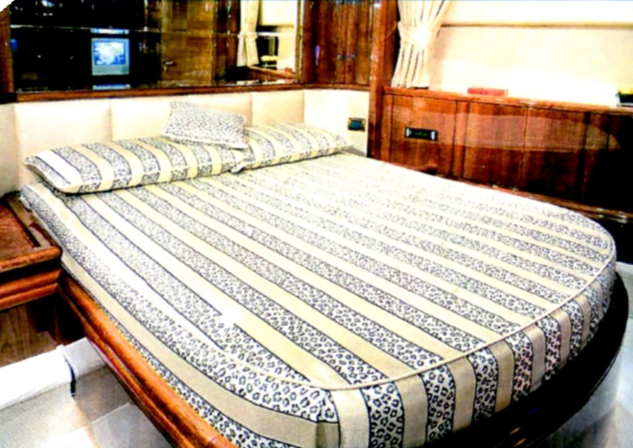 a bed with white sheets aboard FREE SPIRIT Yacht for Sale