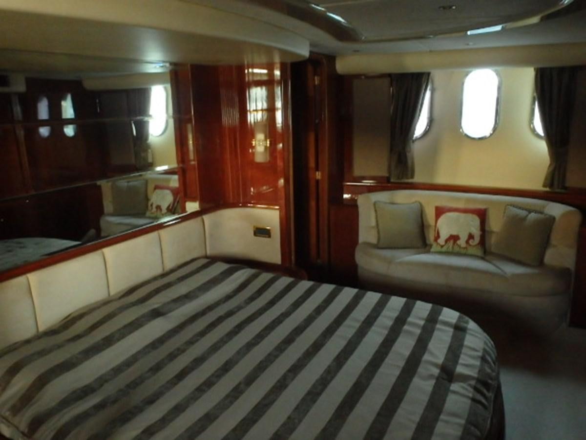 a room with a bed and a couch aboard FREE SPIRIT Yacht for Sale