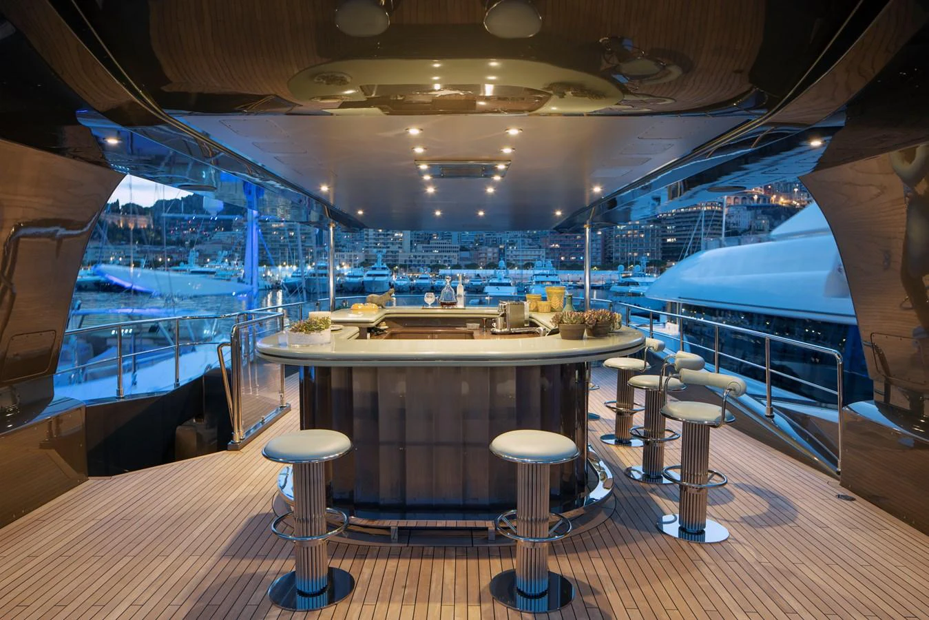 a room with a table and stools aboard MRS L Yacht for Sale